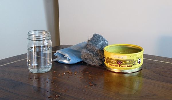 Cloth pad, steel wool and wax for rubbing a finish
