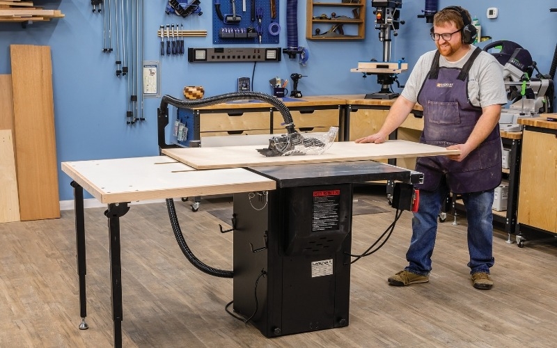 Man using table saw in workshop