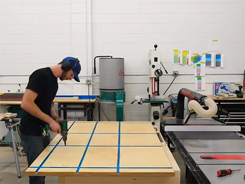 Chris Salomone adding t-tracks to a workbench tabletop