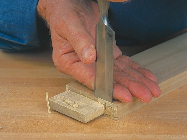 Bench chisel making a cut on a tenon