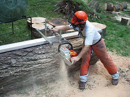 Using chainsaw and rail to cut lumber from a log