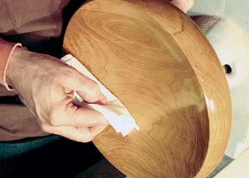 Wiping on a clear polish with a cloth rag