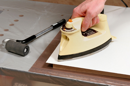 Heating and smoothing laminate adhesive with an iron