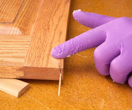 Applying paste wax to crack in wood end