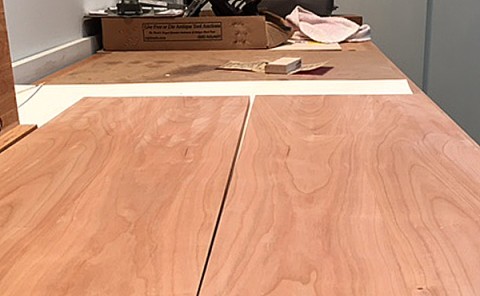 Discolored marks in cherry wood from sanding