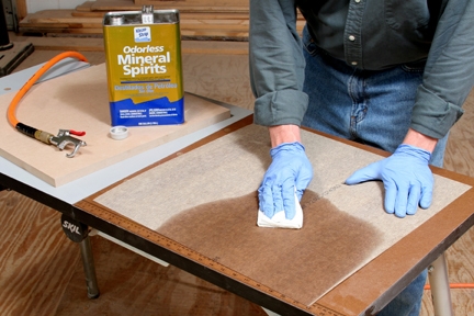 Cleaning laminate sheet backing with mineral spirits