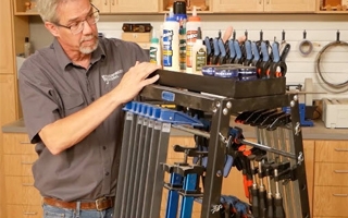 man standing next to mobile clamp rack