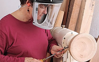 man turning project on wood lathe