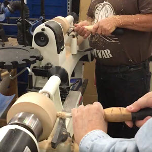 People working on a wood lathe