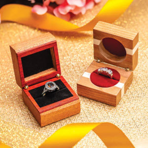 wooden ring box with open top showing ring